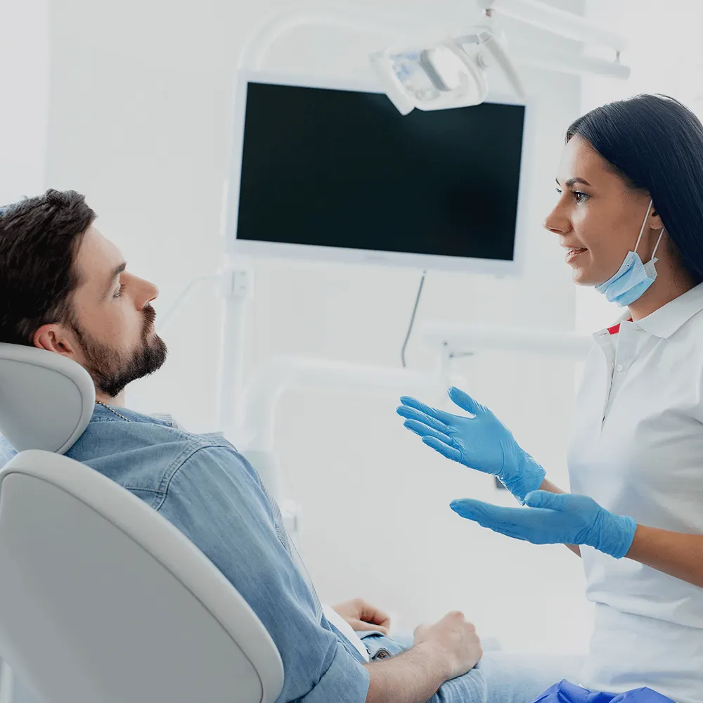 Dentist talking to patient.
