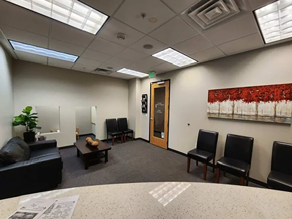 CJ Dental office waiting area with sofas and chairs.